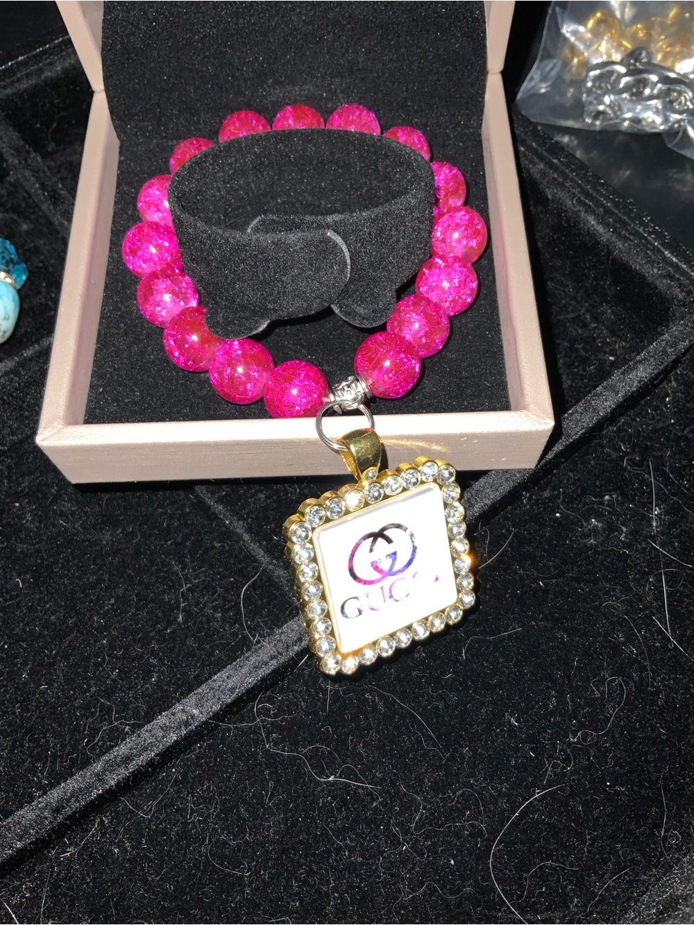 Pink Beaded Bracelet with Gold Rhinestone Logo Pendant